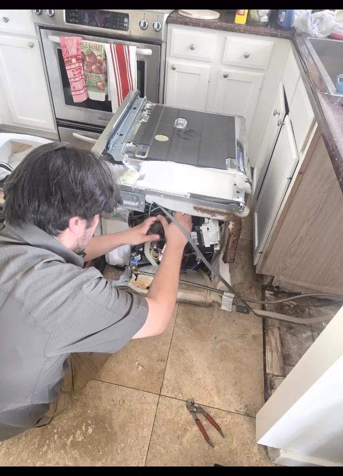 ProMaster technician repairing a pulled-out wall oven