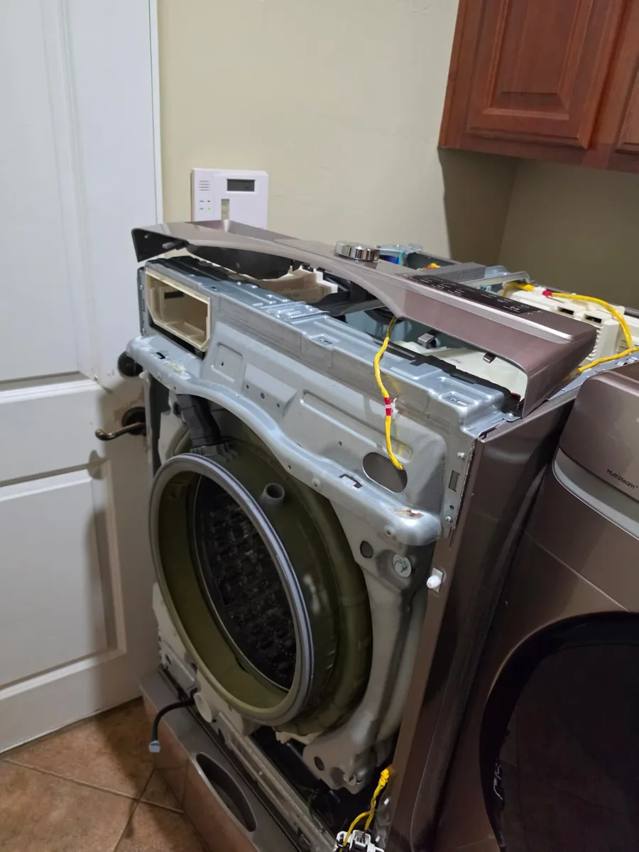 Samsung WF45R6100AC front-load washer with the console removed during shock absorber replacement in Phoenix