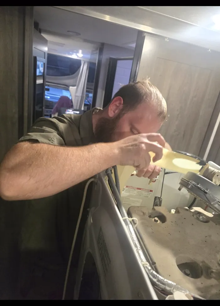 ProMaster technician servicing an all-in-one washer and dryer unit